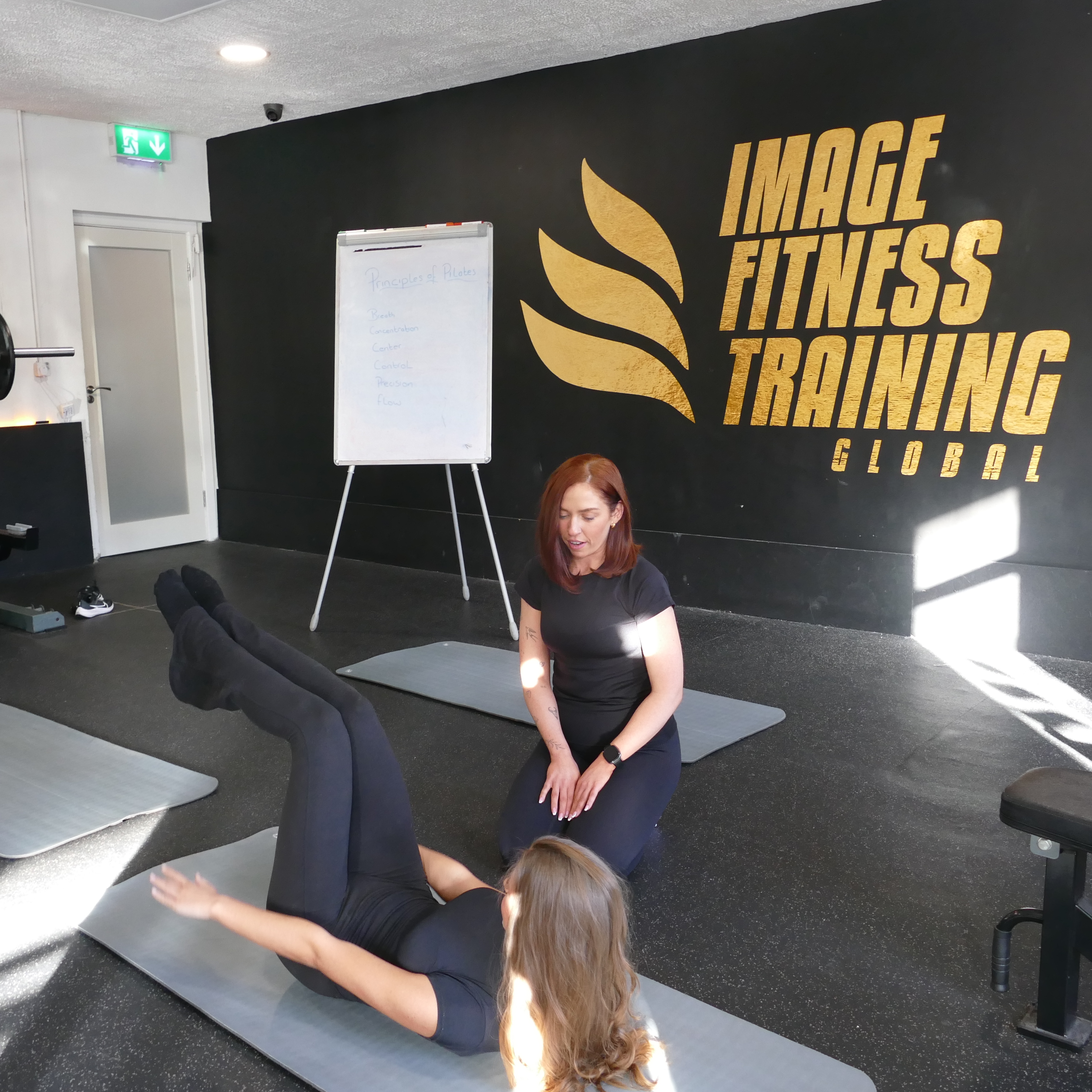 Senior Pilates instructor leading a reformer class at The Studio, Castle Shopping Centre, Swords